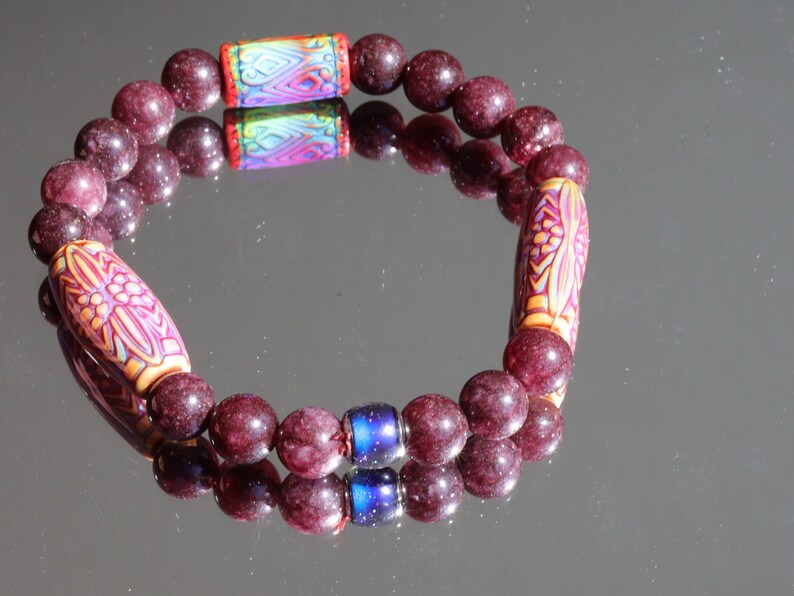 Color-changing Mirāja collection. Dark Red Garnet Jade Beads with Mirage Mood Daisy Ray. making it a popular choice for spiritual practices