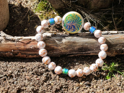 Color-changing Mirāja collection. White Turquoise Gold Color Wire Pine bracelet. Mirage Mood Fountain Fern Coin and Changing barrel beads.