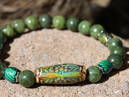 Color-changing Mood Mirāja collection. Green Chalcedony Stone bracelet with Mirage Mood Daisy Ray Bead and  Color Changing barrel beads.