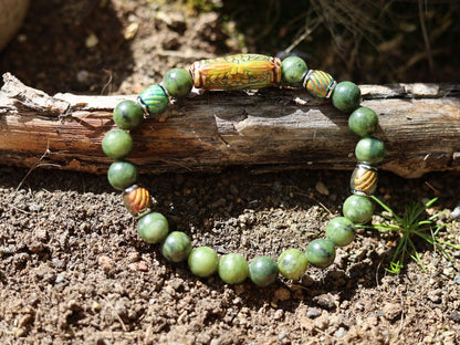 Color-changing Mood Mirāja collection. Green Chalcedony Stone bracelet with Mirage Mood Daisy Ray Bead and  Color Changing barrel beads.