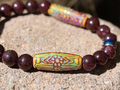 Color-changing Mirāja collection. Dark Red Garnet Jade Beads with Mirage Mood Daisy Ray. making it a popular choice for spiritual practices