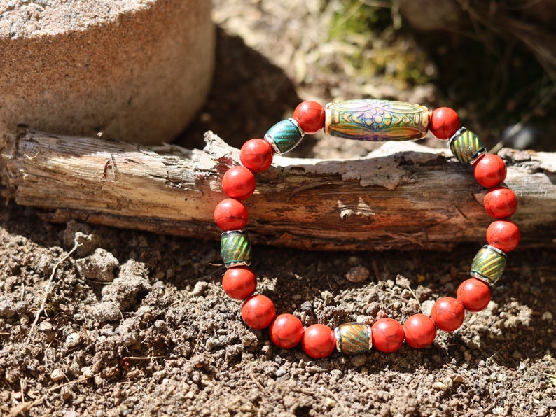 Color-changing Mirāja collection.  Natural Stone Red Howlite Turquoise bracelet with Mirage Mood Daisy Ray. Creating unique colors.