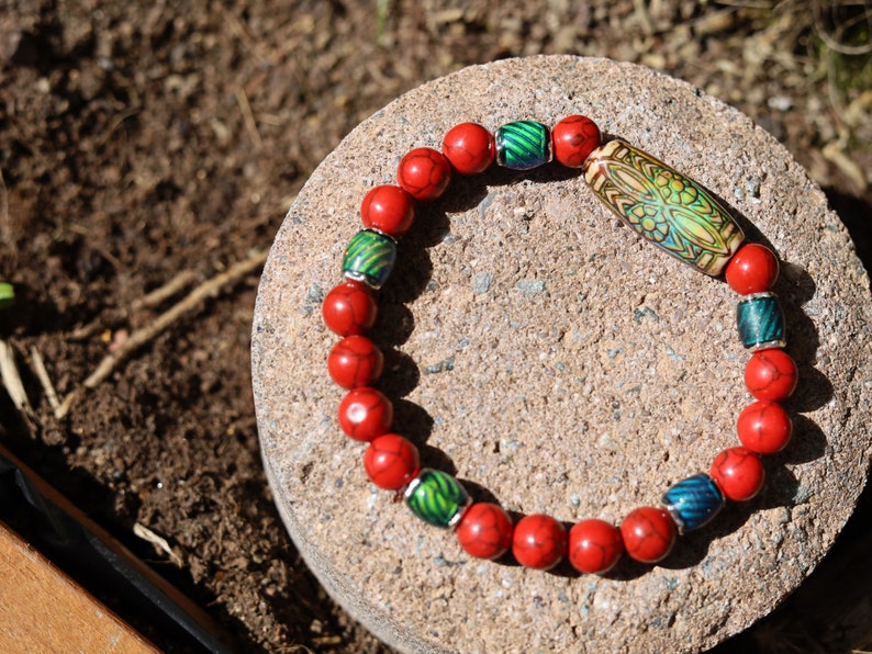 Color-changing Mirāja collection.  Natural Stone Red Howlite Turquoise bracelet with Mirage Mood Daisy Ray. Creating unique colors.
