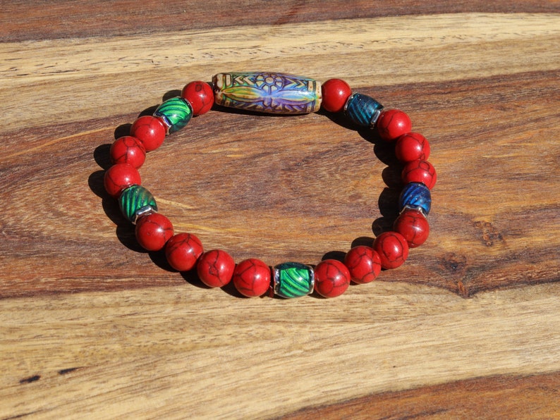 Color-changing Mirāja collection.  Natural Stone Red Howlite Turquoise bracelet with Mirage Mood Daisy Ray. Creating unique colors.