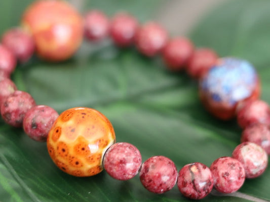 Unique Gorgeous Aggie Maroon Jade Beads bracelet with 16 mm red/ orange beads. Meaningful & symbolic merchandise. Durable stretchy cord