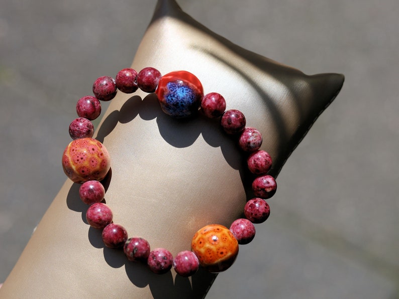 Unique Gorgeous Aggie Maroon Jade Beads bracelet with 16 mm red/ orange beads. Meaningful & symbolic merchandise. Durable stretchy cord