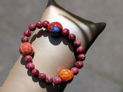 Unique Gorgeous Aggie Maroon Jade Beads bracelet with 16 mm red/ orange beads. Meaningful & symbolic merchandise. Durable stretchy cord