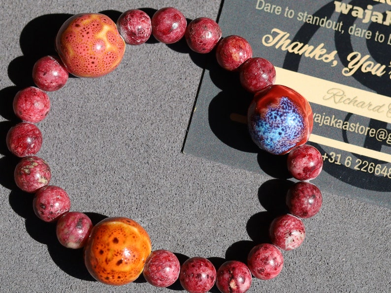 Unique Gorgeous Aggie Maroon Jade Beads bracelet with 16 mm red/ orange beads. Meaningful & symbolic merchandise. Durable stretchy cord
