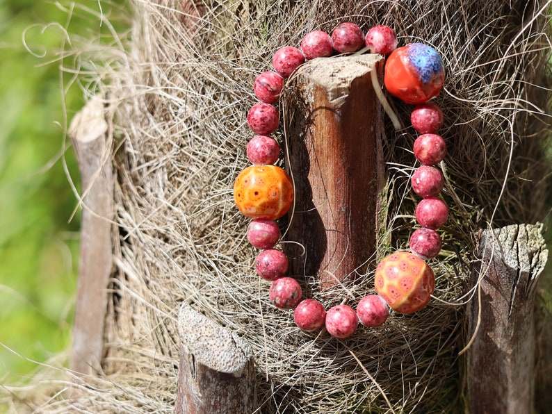Unique Gorgeous Aggie Maroon Jade Beads bracelet with 16 mm red/ orange beads. Meaningful & symbolic merchandise. Durable stretchy cord