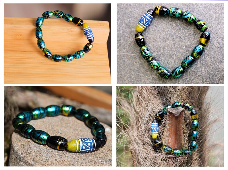 Glass beads with an impressive finish. Cosmic Oval Black w Gold 10x14mm. Combined with Glassbead aqua-red with white and yellow dots, 27x16 mm. Total weight approx 32 gr.