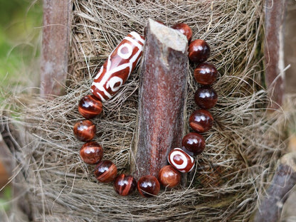 12 mm Red Tiger's Eye beaded bracelet with unique Red/ white big Dzi 6 eyes.  often used in prayer and meditation practices