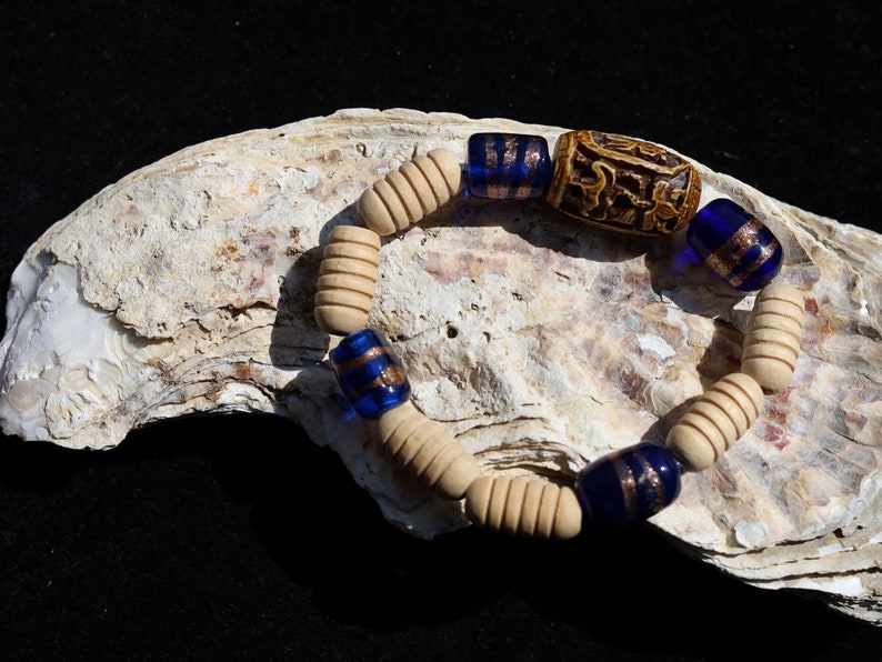 Wooden Turned  beads with Glass bead cobalt blue tubes. And reat authentic look & feel - carved decoration of a Lotus flower