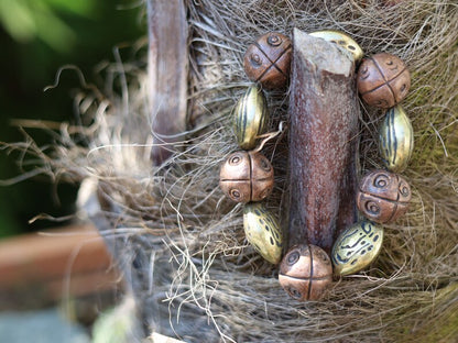 Metallook bead bronze almond shape beads with Metallook bead bronze round with dots.  a powerful way to express your individuality
