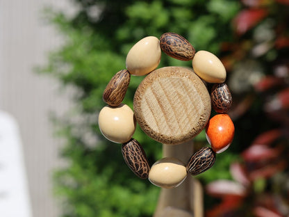 Beautiful large dark brown Kili seeds with Lumbang seed orange / light pink. Lumbang seeds are used for their protective properties