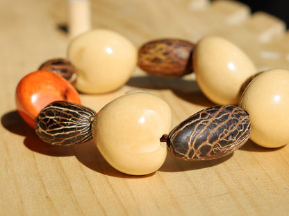 Beautiful large dark brown Kili seeds with Lumbang seed orange / light pink. Lumbang seeds are used for their protective properties