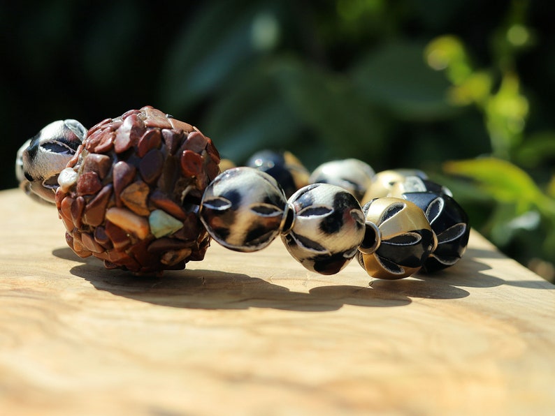 Chunk bead brown stone covered with different light brown colored stones. Combined with Mixed colors Leather Beads.