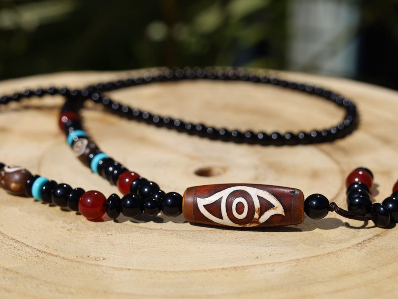 Eye Dzi pattern necklace with 2 eyed dzi and and a Agate Stone beaded necklace. The longer the Dzi exist, the more potent it becomes