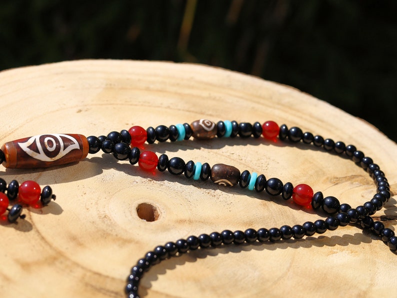 Eye Dzi pattern necklace with 2 eyed dzi and and a Agate Stone beaded necklace. The longer the Dzi exist, the more potent it becomes