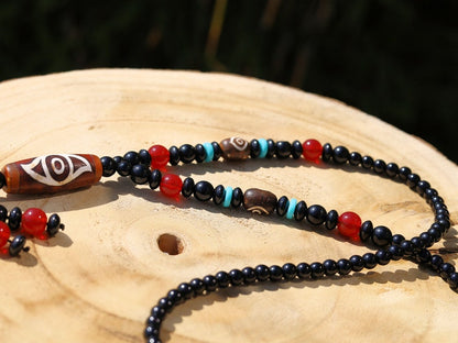 Eye Dzi pattern necklace with 2 eyed dzi and and a Agate Stone beaded necklace. The longer the Dzi exist, the more potent it becomes