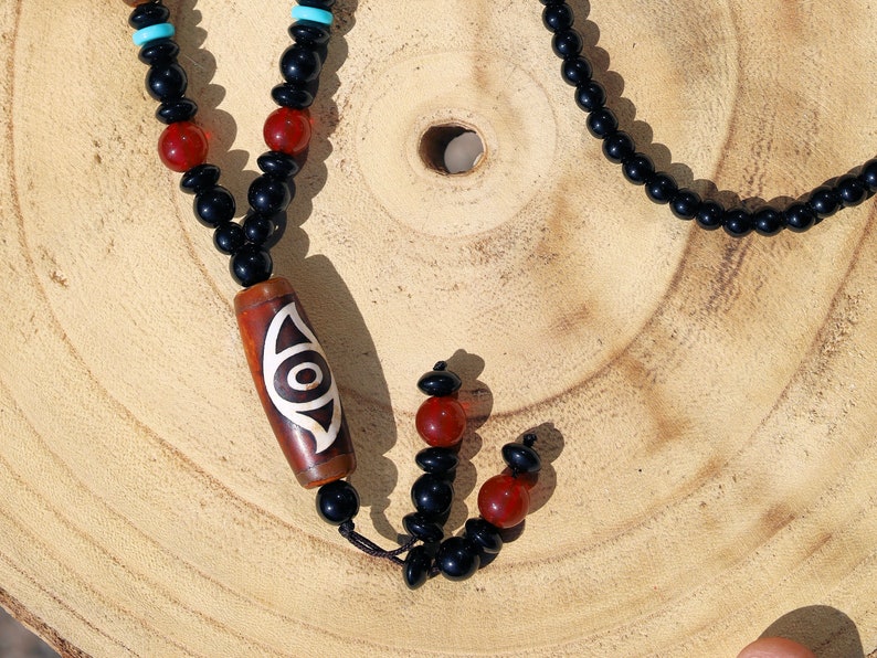 Eye Dzi pattern necklace with 2 eyed dzi and and a Agate Stone beaded necklace. The longer the Dzi exist, the more potent it becomes