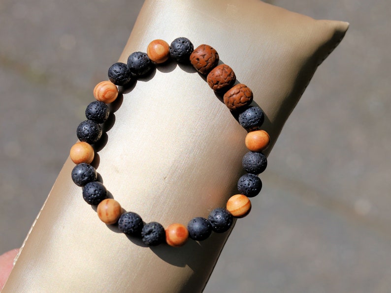 Polished Rudraksha bracelet with Raja Kayu and Lav beads.  the Supreme King in the forest among all different pieces of trees