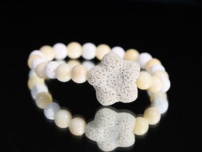Acai broken white seed beaded bracelet with white lava and Off White/Sand color Flower shaped  bead. Enjoying Aromatherapy