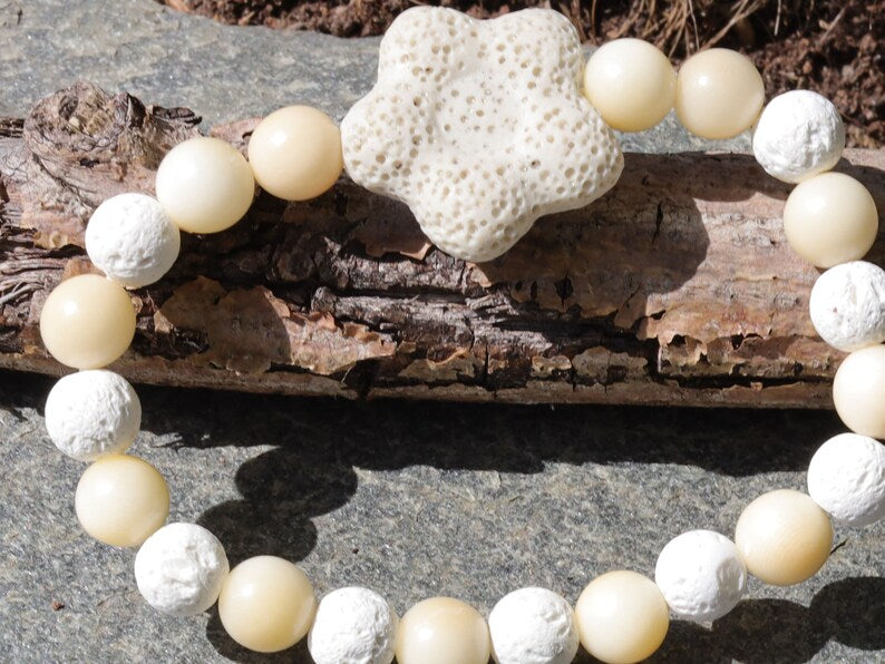 Acai broken white seed beaded bracelet with white lava and Off White/Sand color Flower shaped  bead. Enjoying Aromatherapy