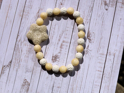 Acai broken white seed beaded bracelet with white lava and Off White/Sand color Flower shaped  bead. Enjoying Aromatherapy