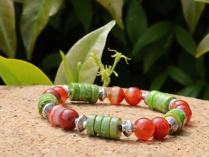 Green Sea Sediment Jasper Gemstone Heishi Spacer bracelet with Banded orange beads. different from what is commonly seen or expected