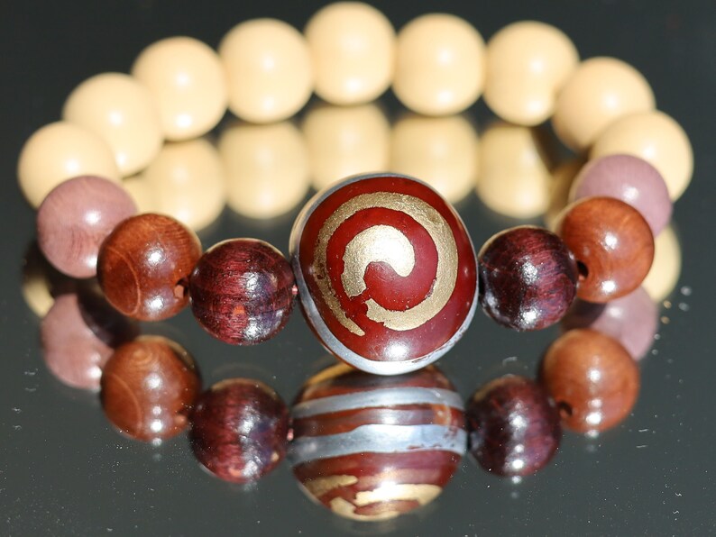 Wooden Spiral bead combined with maple and hornbeam wood. Cultural or Spiritual Significance. a form of self-expression