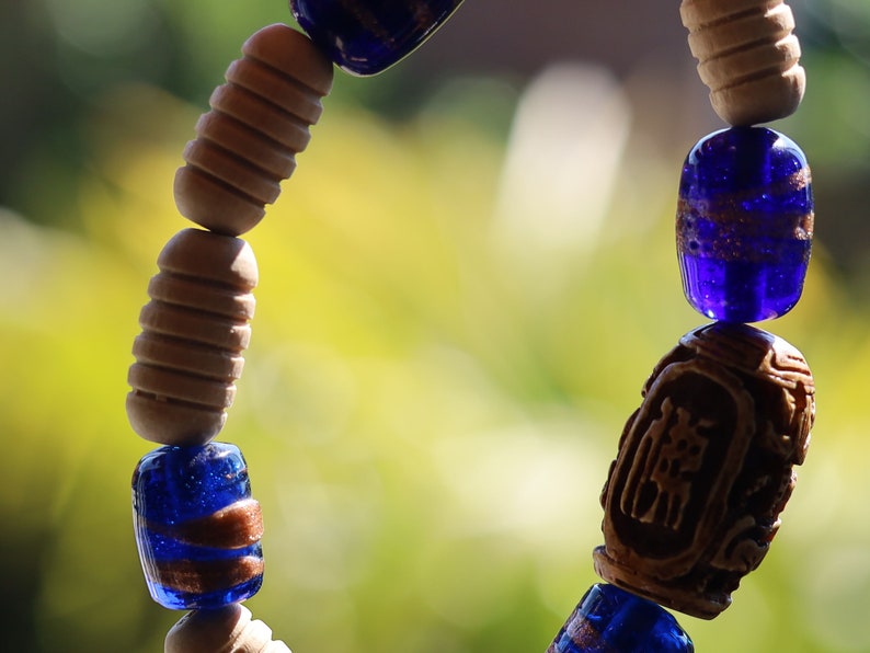 Wooden Turned  beads with Glass bead cobalt blue tubes. And reat authentic look & feel - carved decoration of a Lotus flower