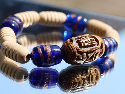 Wooden Turned  beads with Glass bead cobalt blue tubes. And reat authentic look & feel - carved decoration of a Lotus flower