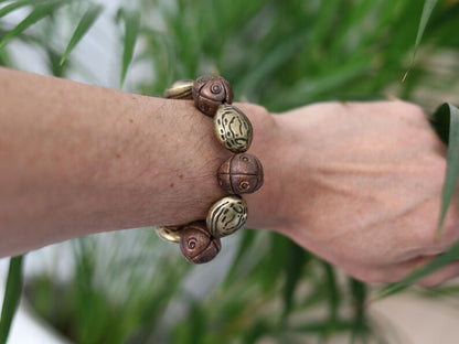Metallook bead bronze almond shape beads with Metallook bead bronze round with dots.  a powerful way to express your individuality