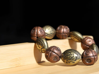 Metallook bead bronze almond shape beads with Metallook bead bronze round with dots.  a powerful way to express your individuality