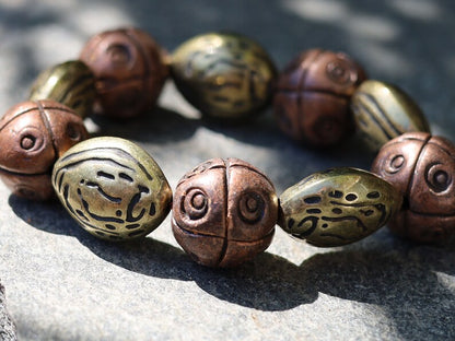 Metallook bead bronze almond shape beads with Metallook bead bronze round with dots.  a powerful way to express your individuality
