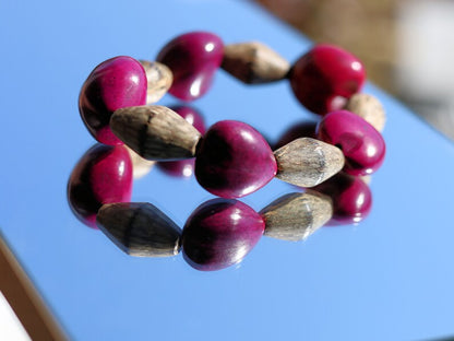 Beautiful large Lumbang seed bordeaux fuchsia Lumbang seed with Palmwood bicone brown beads.