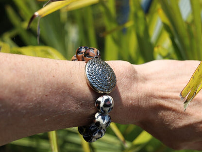 Unique Silver color metal look coin with cable motif with mixed rare  Leather Beads. it can symbolize a connection to the natural world