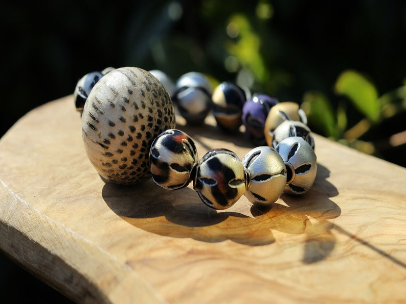 Unique big Palmwood ball brown/ grey, 29 mm with mixed rare Leather Beads. it can symbolize a connection to the natural world