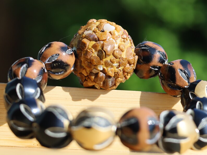 Chunk bead light brown stone covered with different light brown colored stones. Combined with Mixed colors Leather Beads.