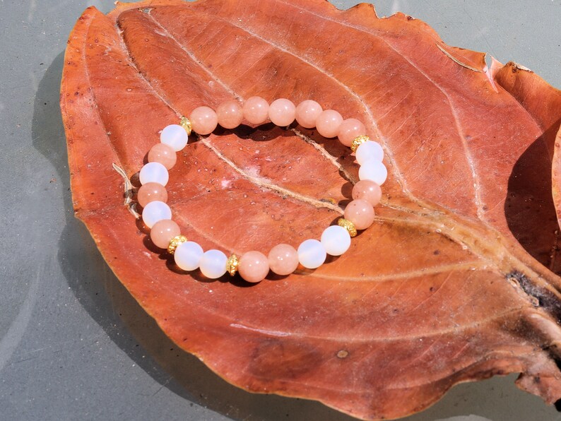 White opal bracelet with Sun stone beads. Sun stone is a unique and captivating gemstone known for its distinctive sparkling appearance.