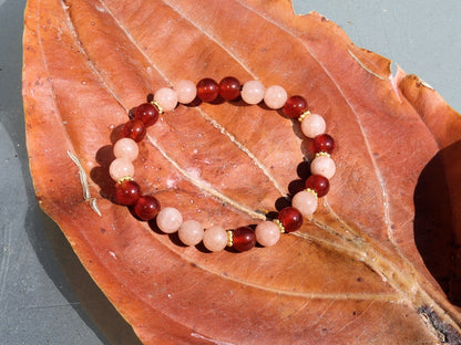 Sun stone bracelet with Carnelian red beads and . Tibetan alloy material in Antique Gold. The energy of the sun