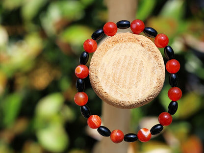 Carnelian red beaded bracelet with  Black Agate Barrel Beads. Agate enhances creativity and strengthens the intellect