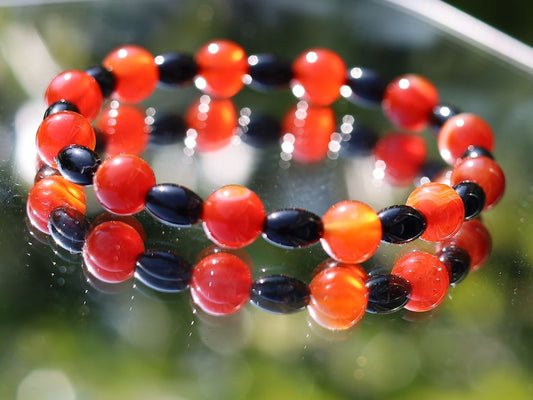 Carnelian red beaded bracelet with  Black Agate Barrel Beads. Agate enhances creativity and strengthens the intellect
