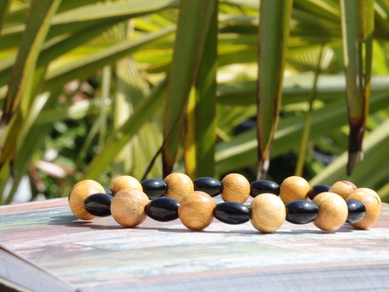 Unique Palo Santo Wood bracelet combined with Natural Black Agate Barrel Beads. Perfect handmade gifts and on-trend unique jewelry.