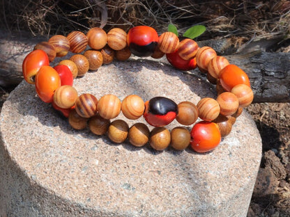 Wooden Bracelet set.  Madre de Cacao Wood beads with 5x Huayruro grande.  Raja Kayu matte beads with 5x Huayruro grande