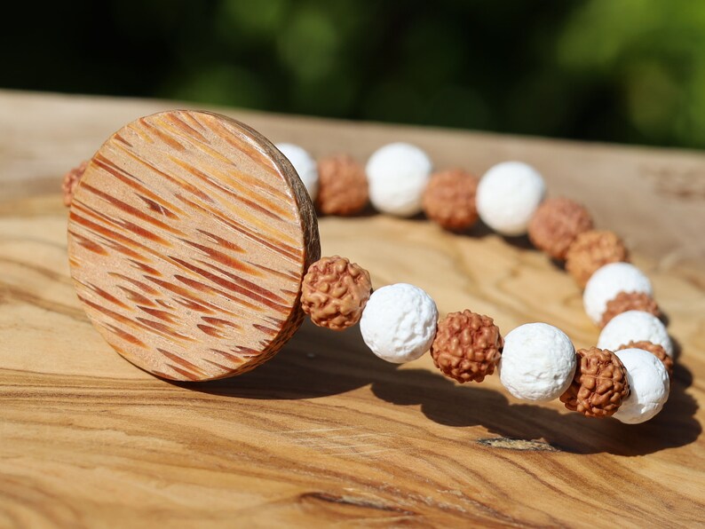 Beautiful, large Palm Wood bead with Lava and Round Rudraksha beads. Overall, white lava beads offer a unique  element to jewelry designs