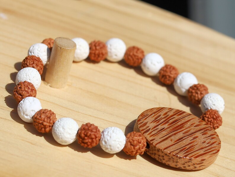 Beautiful, large Palm Wood bead with Lava and Round Rudraksha beads. Overall, white lava beads offer a unique  element to jewelry designs