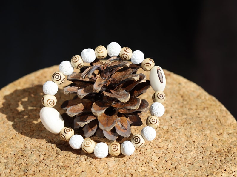 Huayruro white beads bracelet with white Lava and Wooden beads with spiral..offer a unique and natural element to jewelry