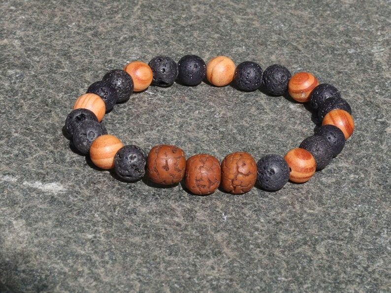 Polished Rudraksha bracelet with Raja Kayu and Lav beads.  the Supreme King in the forest among all different pieces of trees
