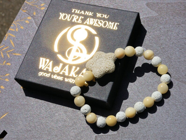 Acai broken white seed beaded bracelet with white lava and Off White/Sand color Flower shaped  bead. Enjoying Aromatherapy